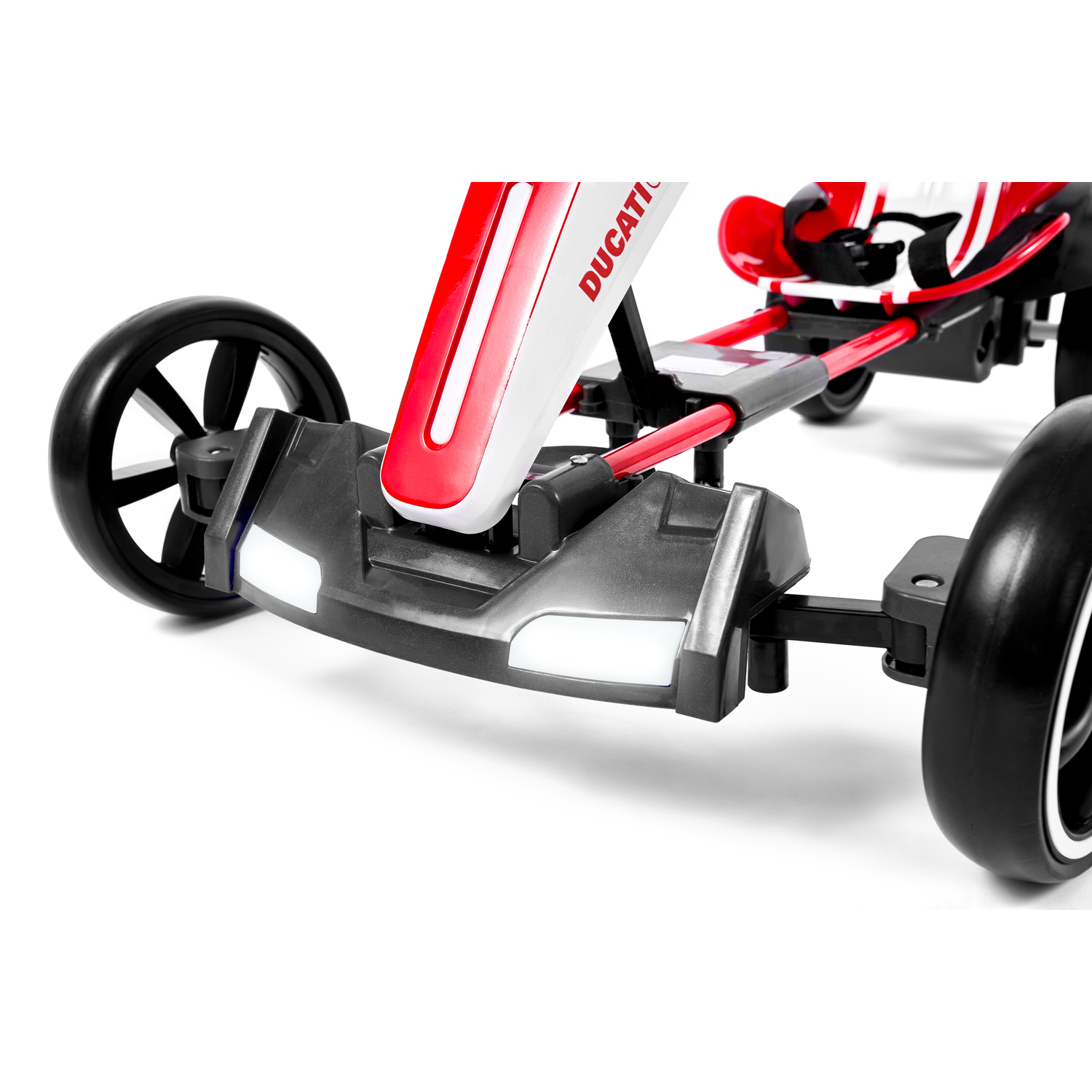 A close-up of a red and white Ducati go-kart on a white background. Black tires and seat with Ducati logo are visible.