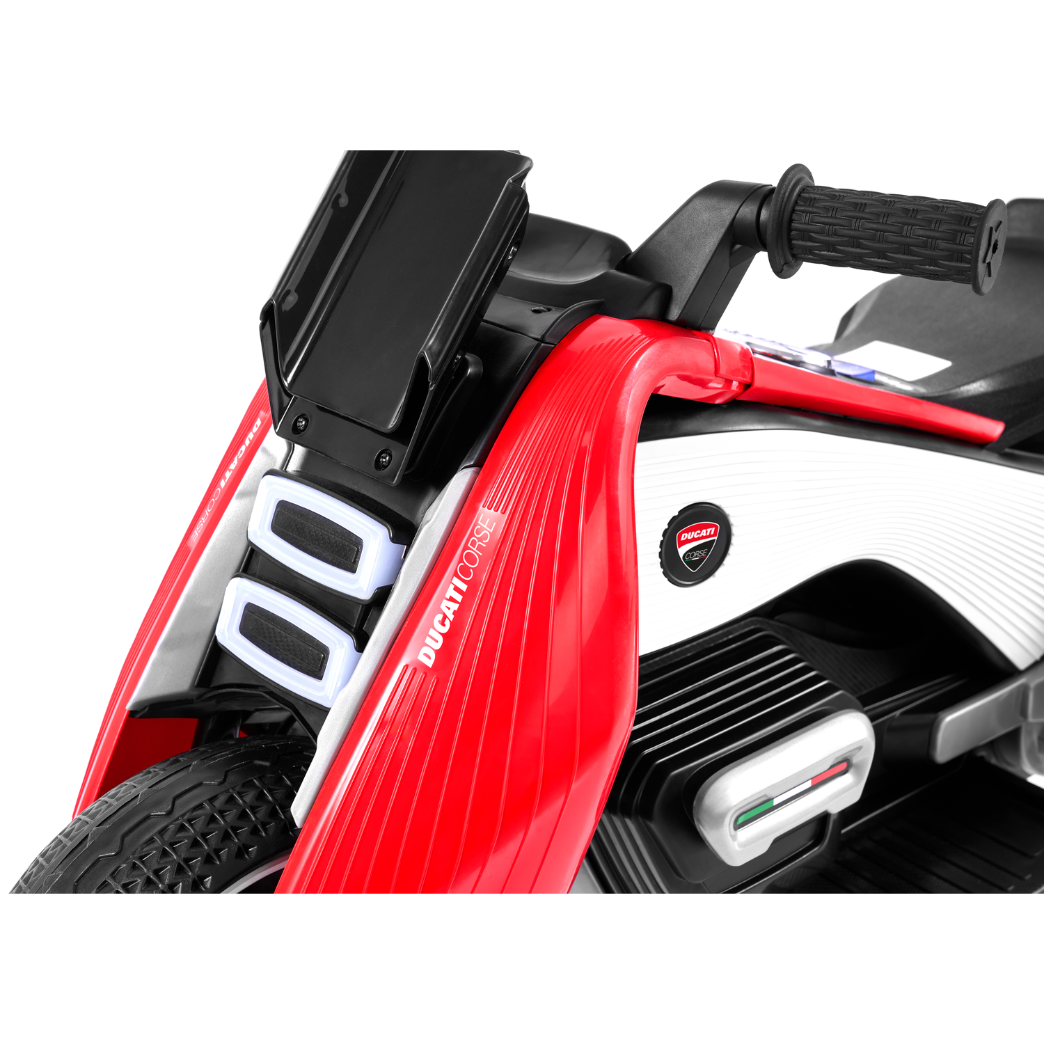 Close-up of a red and white Ducati toy motorcycle. Details include handlebars, headlights, and the Ducati Corse logo.