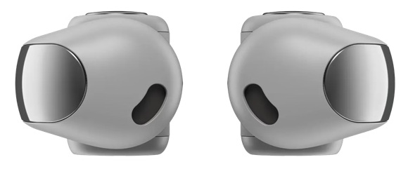 Dwa białe i srebrne słuchawki, widok z boku. Każda ma zaokrąglony korpus, srebrną ścianę i czarny owalny otwór.