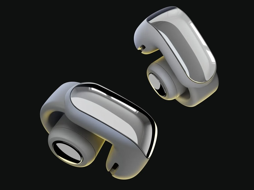 Dwa szare i srebrne bezprzewodowe słuchawki unoszące się na czarnym tle. Słuchawki mają nowoczesny, elegancki design.