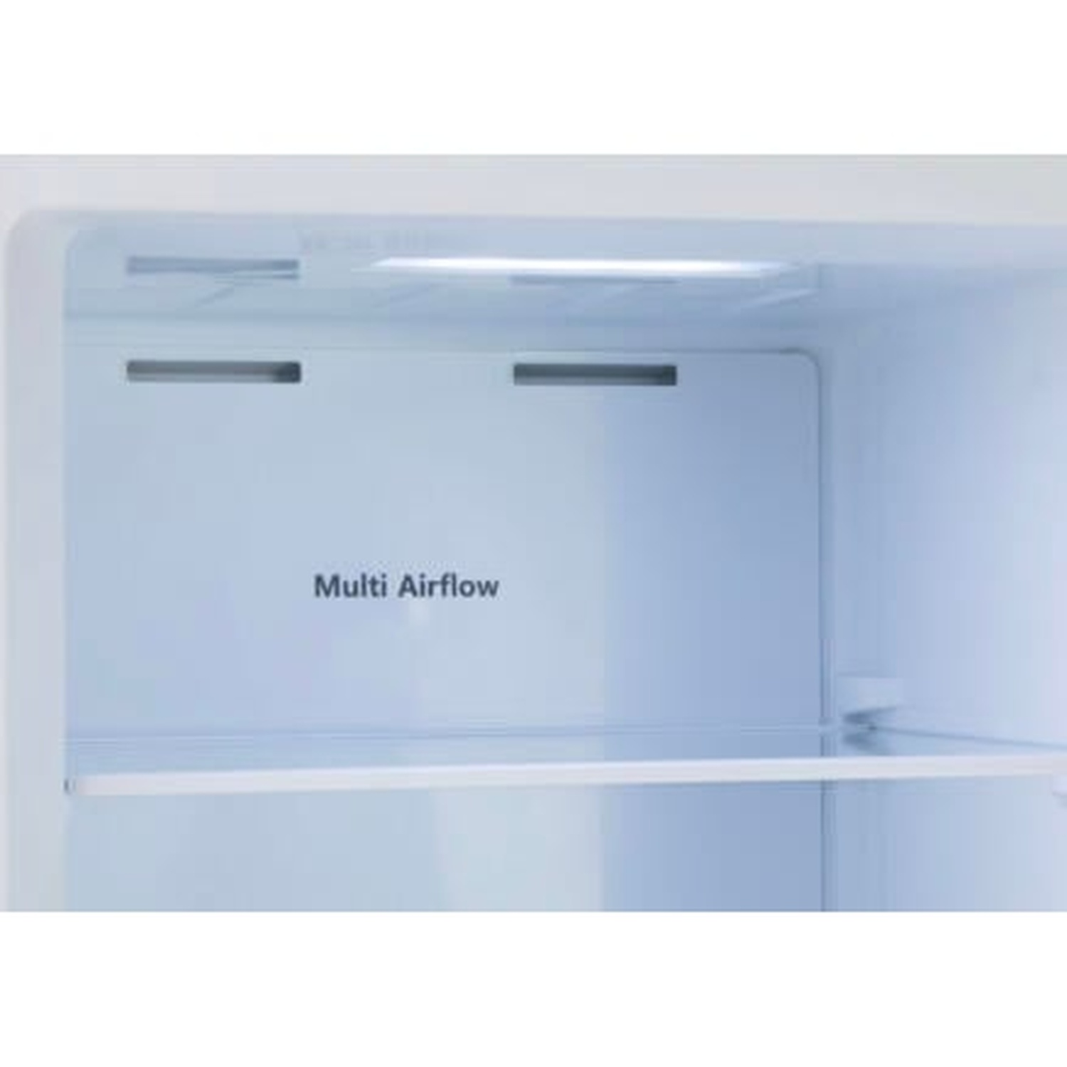 Intérieur d'un réfrigérateur vide avec panneau 'Multi Airflow'. Une lumière illumine le haut. Une étagère est visible.