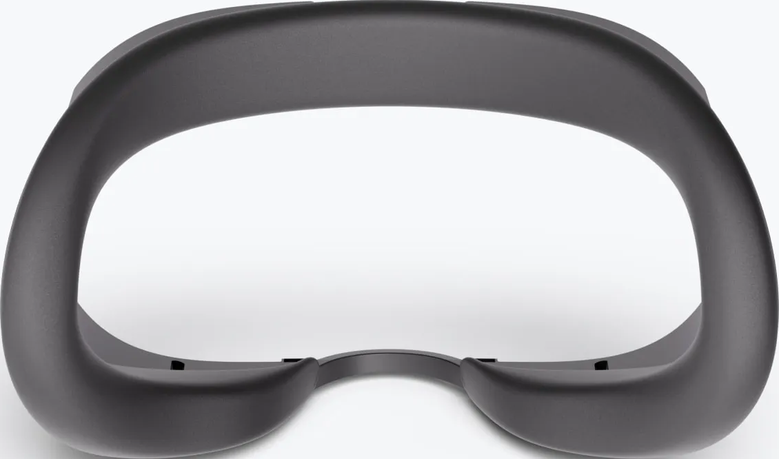 Un telaio per visore VR grigio scuro. Il telaio ha un design curvo con aperture per gli occhi, con sfondo bianco.