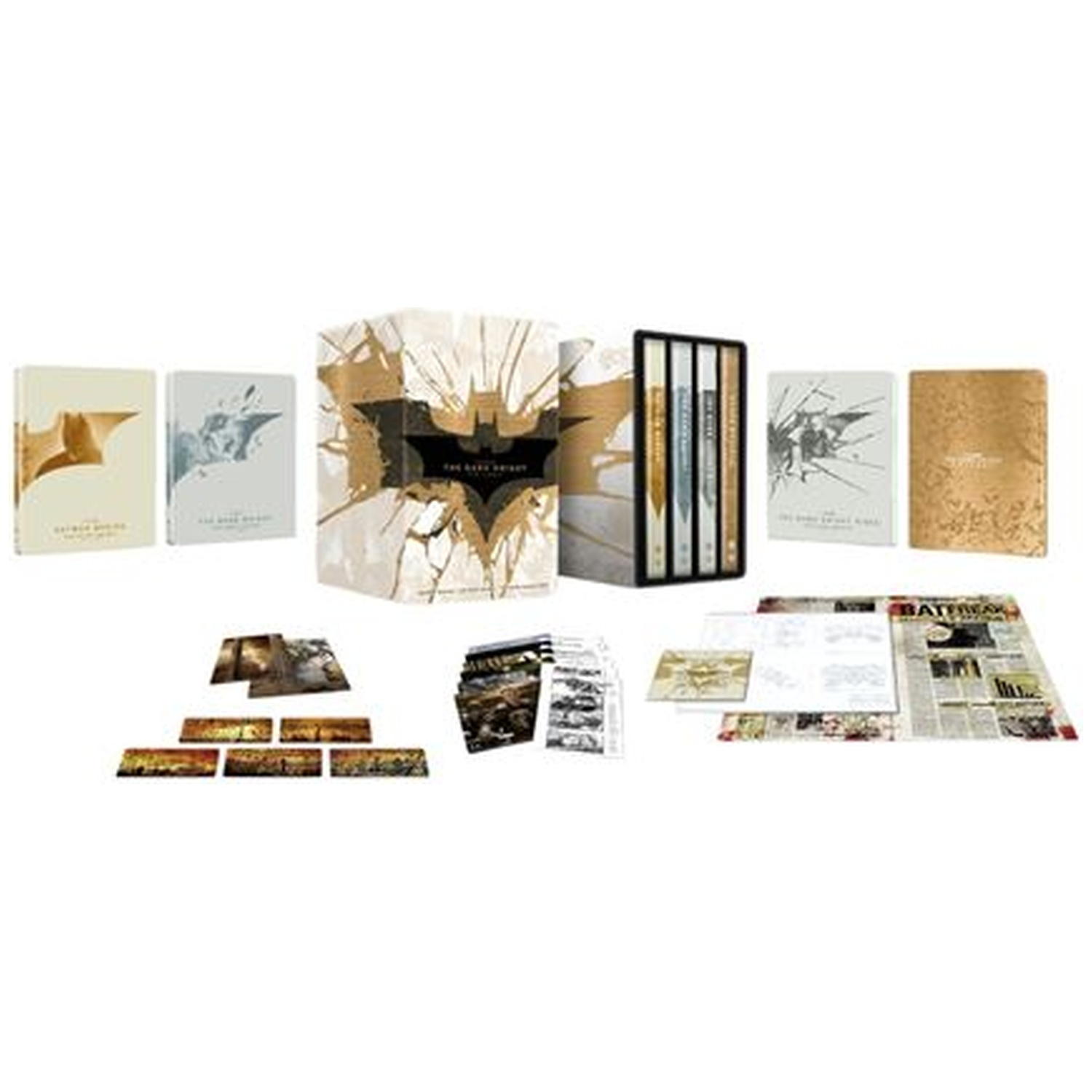 A Batman movie box set. Includes several books, movie cases, and other collectibles, arranged on a white surface.