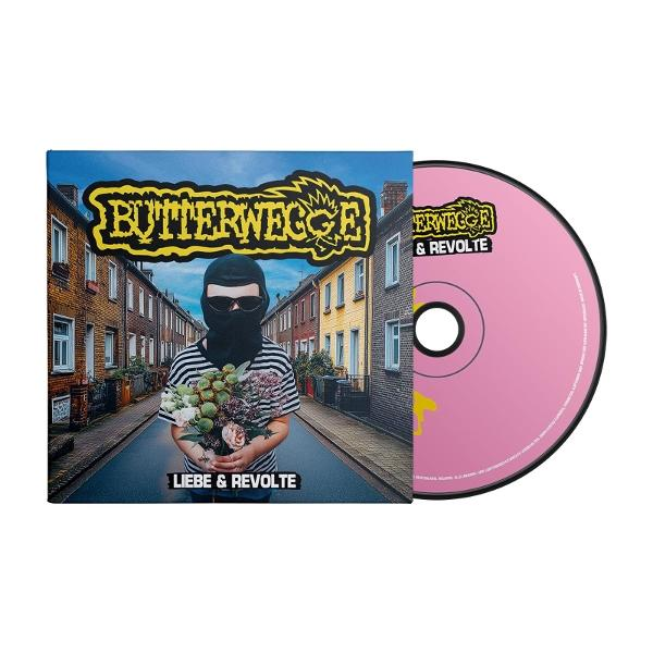 Albumcover mit Person in Sturmhaube, die Blumen hält, die Straße dahinter. Pinkfarbene CD ist sichtbar.