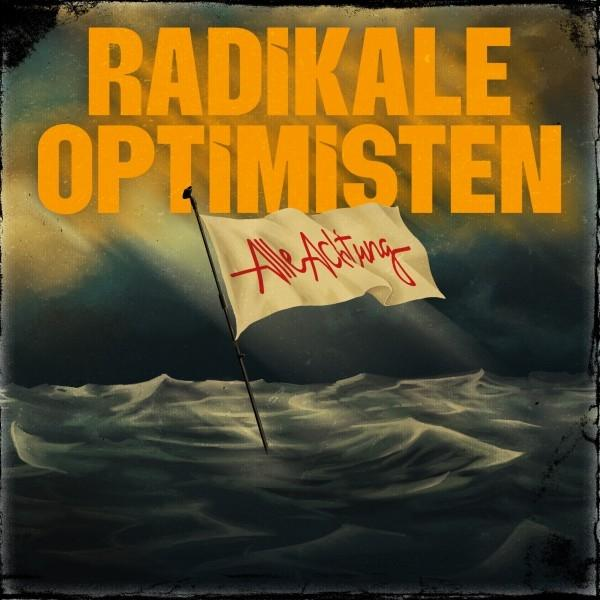 Poster mit orangefarbenem Text 'RADIKALE OPTIMISTEN'. Eine weiße Flagge mit rotem Text 'Alle Achtung' weht über den Meereswellen.