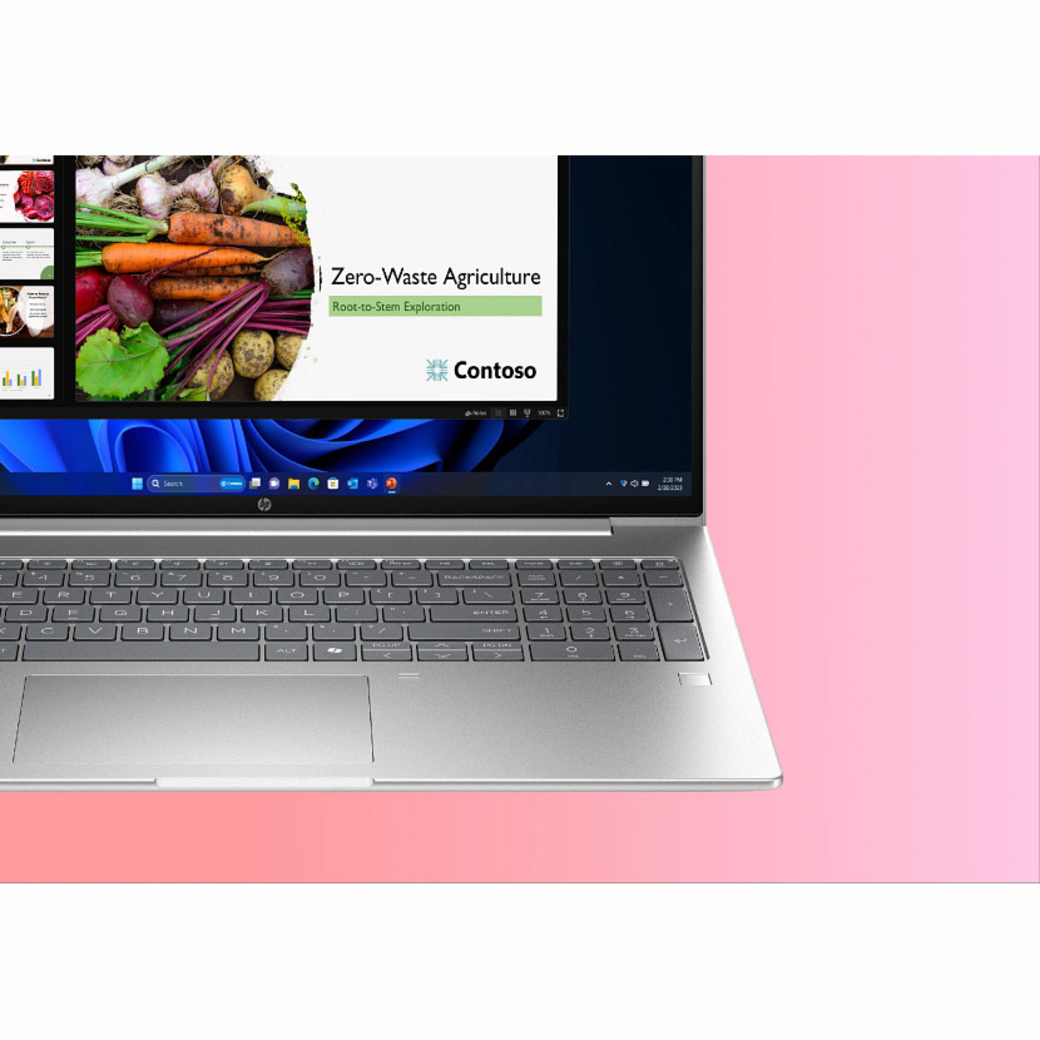 Laptop displaying a presentation on zero-waste agriculture. Vegetables on screen. Laptop keyboard in focus, set against a pink background.