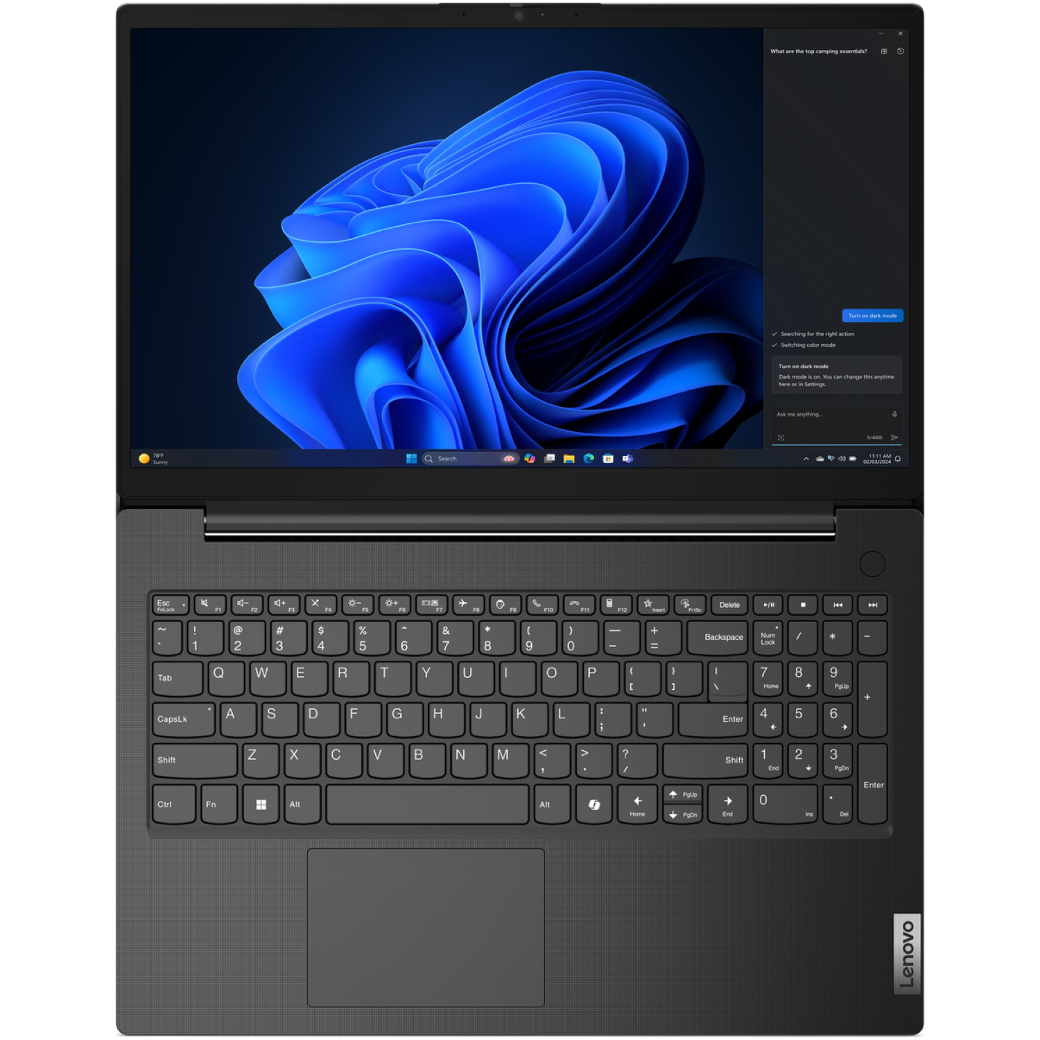 A black Lenovo laptop displays a blue abstract background. The keyboard is visible, along with a search bar and a menu.
