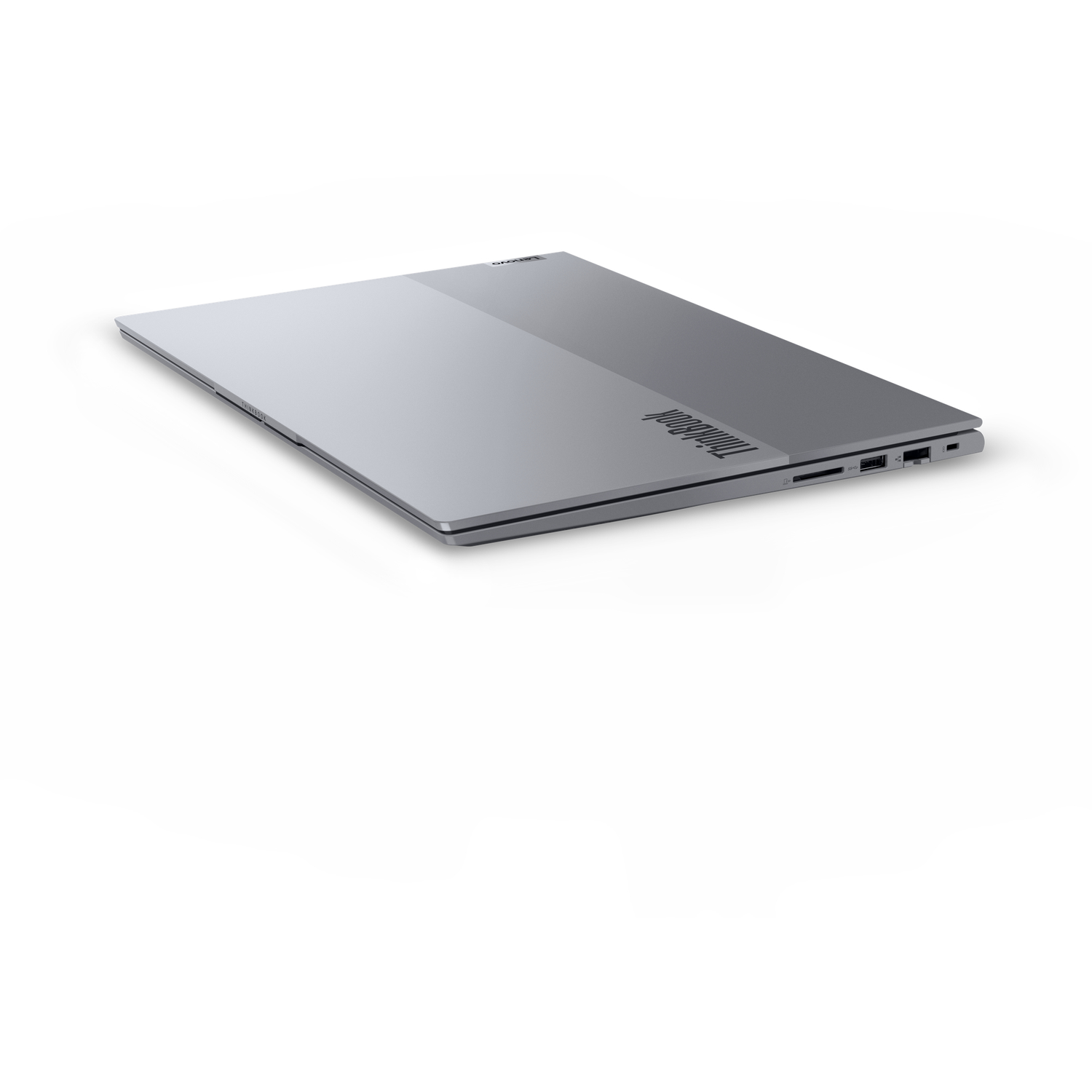 A silver ThinkBook laptop on a white background. The laptop is slightly angled, showing its side ports and ThinkBook logo.