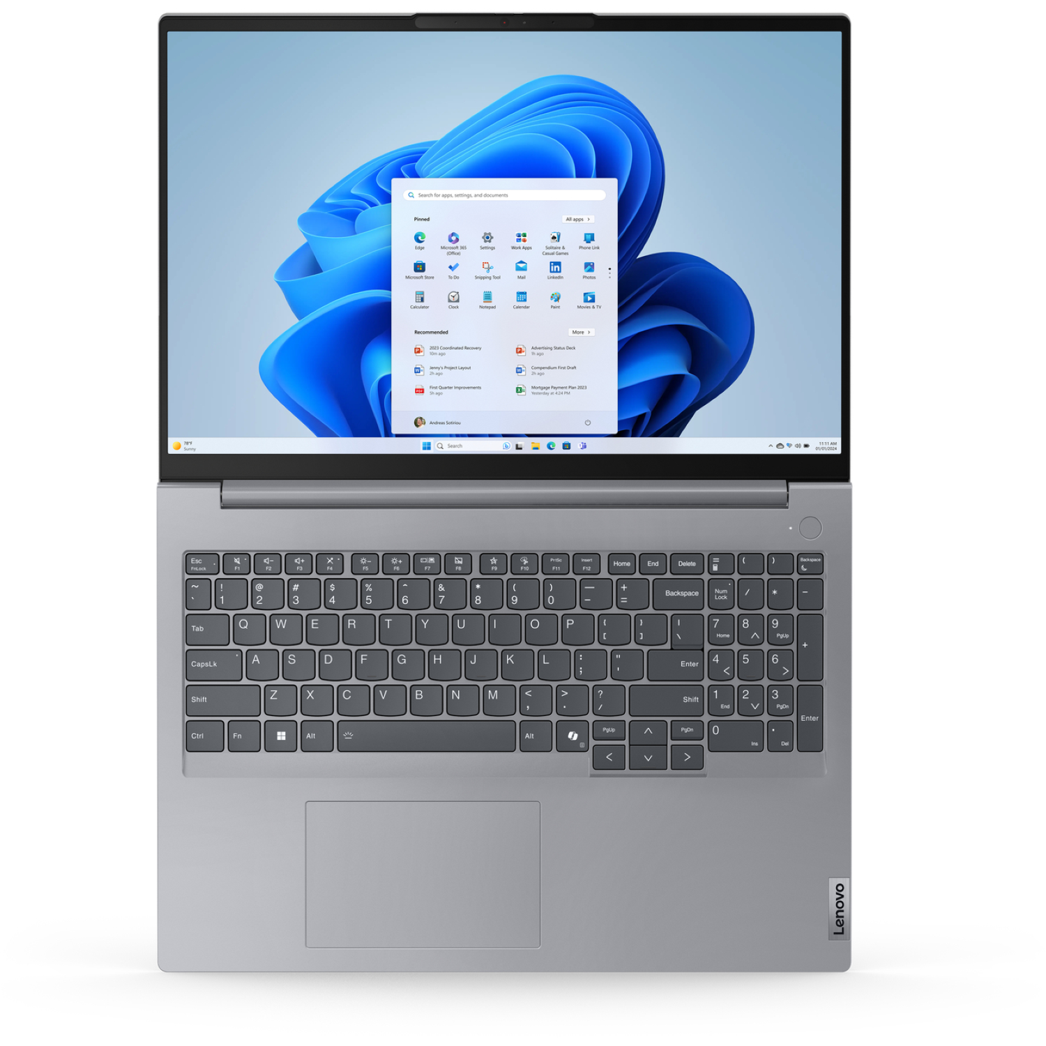 A Lenovo laptop open, showing the Windows 11 interface. The screen displays the start menu and a search bar.