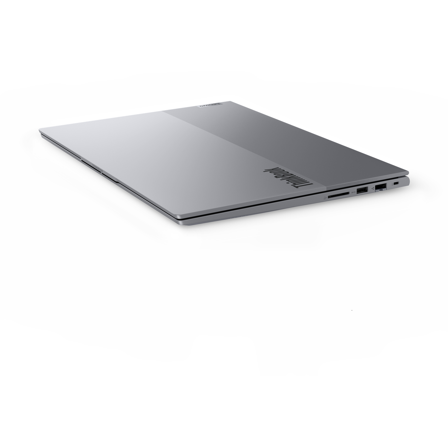 A closed, silver Lenovo ThinkBook laptop is angled on a white surface. The ThinkBook logo is visible on the bottom right.