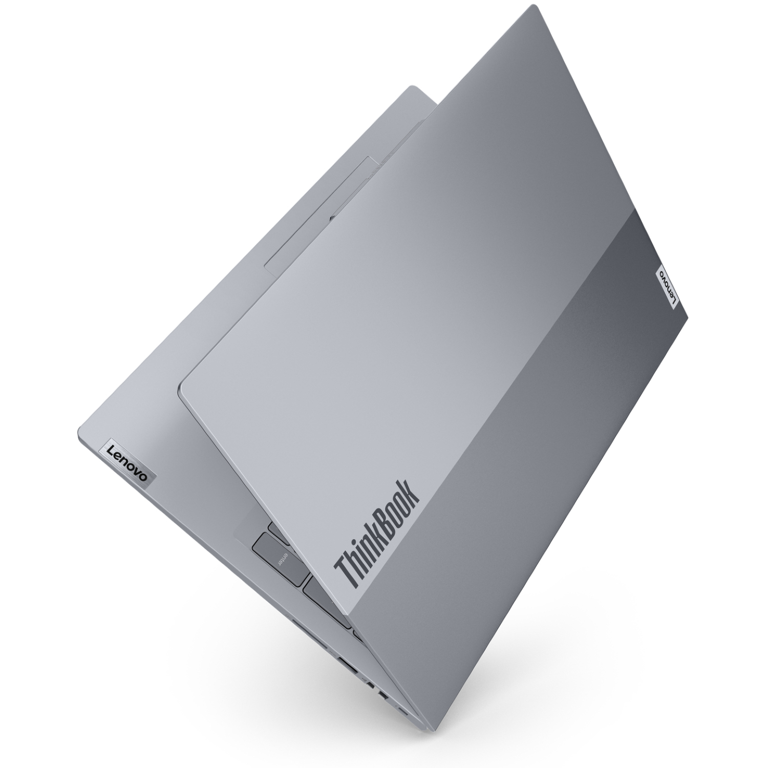 A silver Lenovo ThinkBook laptop is angled open on a white surface. The ThinkBook logo and Lenovo logo are visible.