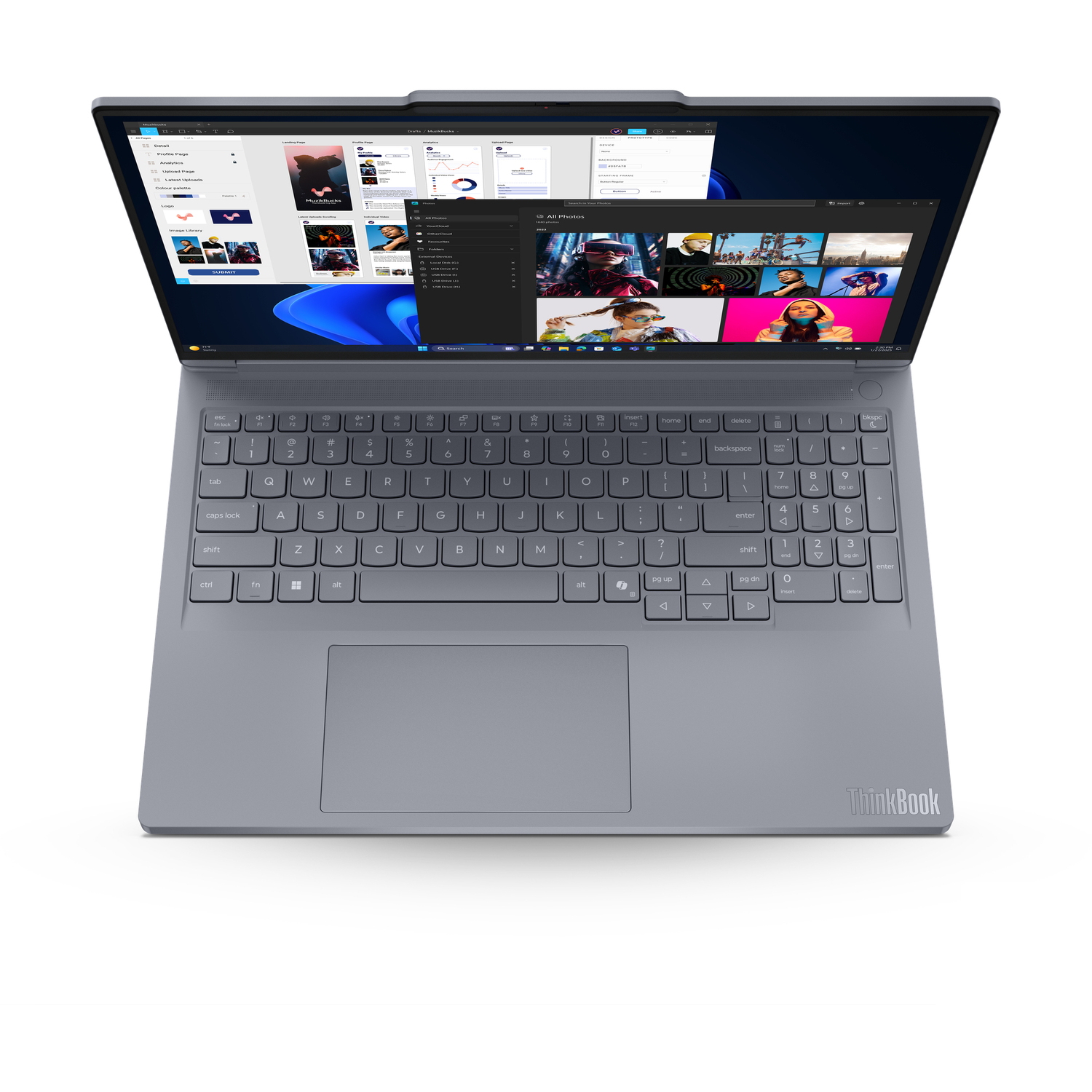 A gray ThinkBook laptop is open, displaying various application windows. The keyboard and trackpad are visible. The screen shows images.