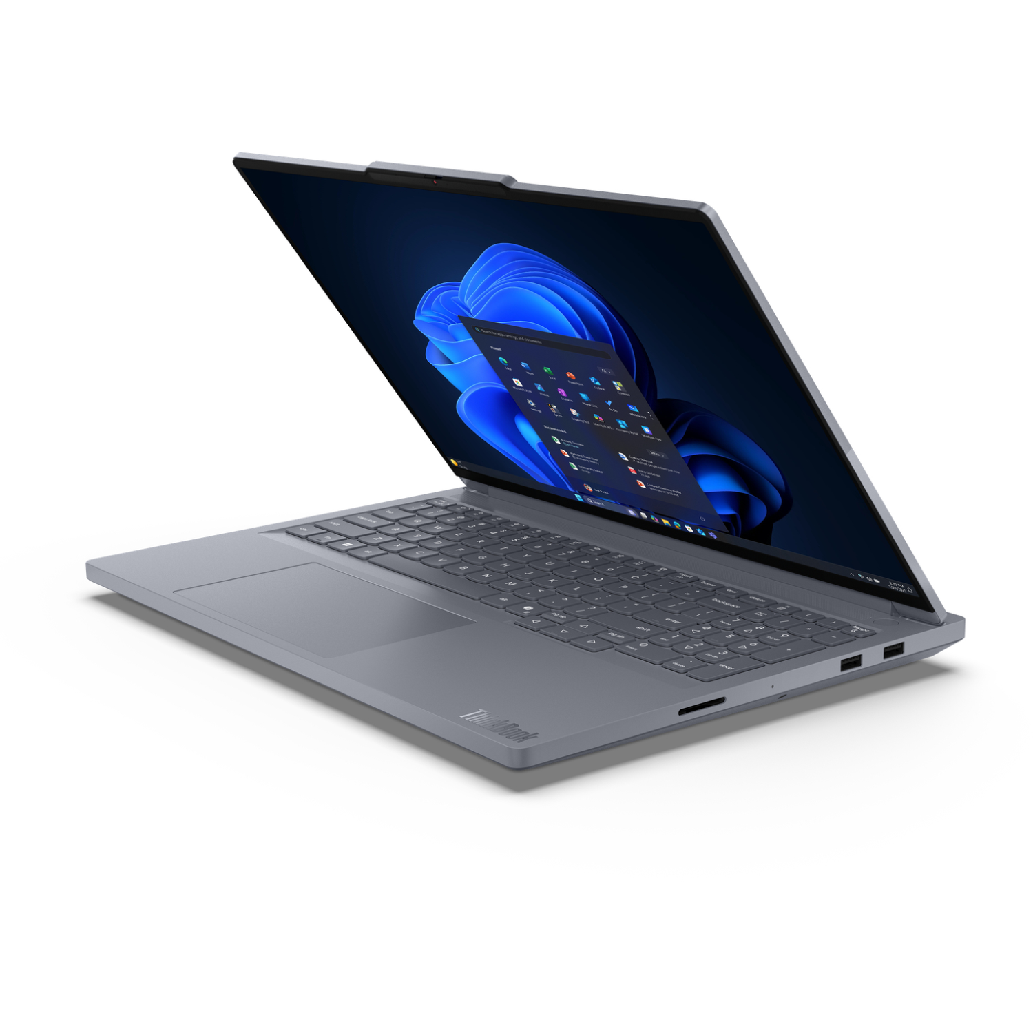 A gray ThinkBook laptop is open, showing a Windows 11 desktop. The screen displays apps and a blue abstract background.