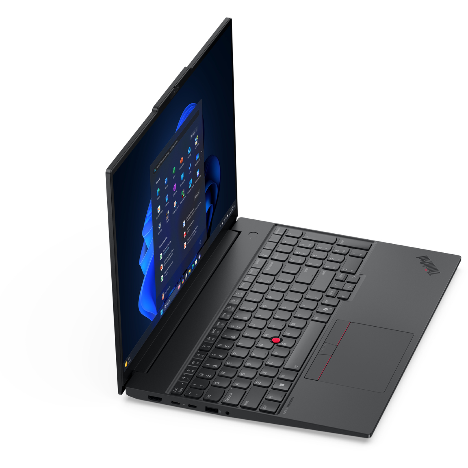Black laptop open on a white surface. The screen displays the Windows 11 interface. Keyboard and touchpad are visible.