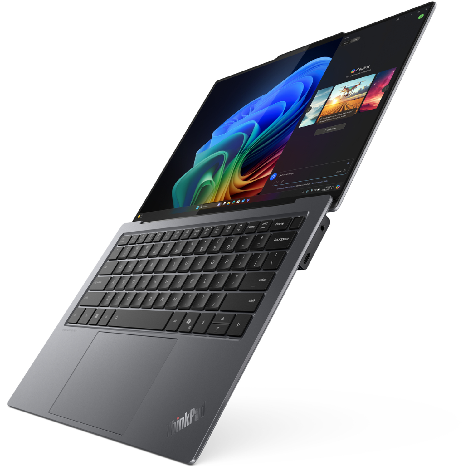 A gray ThinkPad laptop is slightly open, showing a keyboard and screen with a colorful abstract background and app interface.