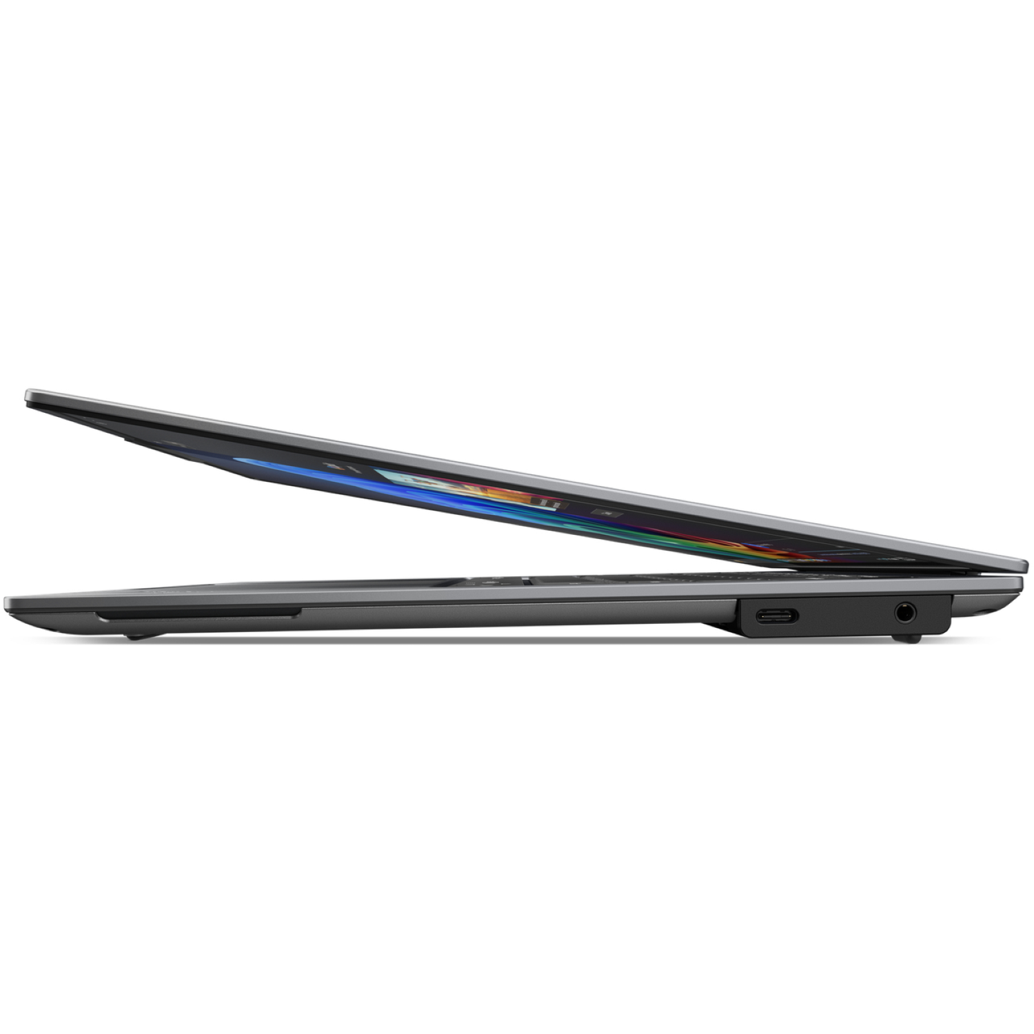 Side view of a gray laptop, partially open. The screen shows colorful display. A USB-C port and audio jack are visible.