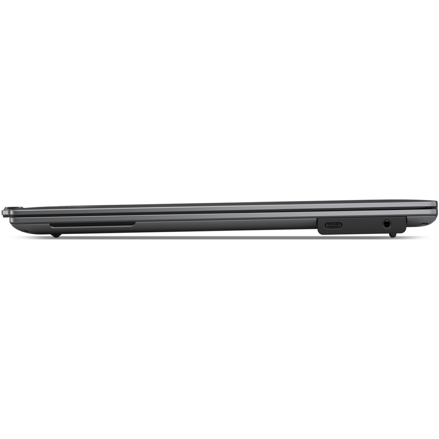 A closed, dark gray laptop is viewed from the side. Ports are visible, including a USB-C and a headphone jack.