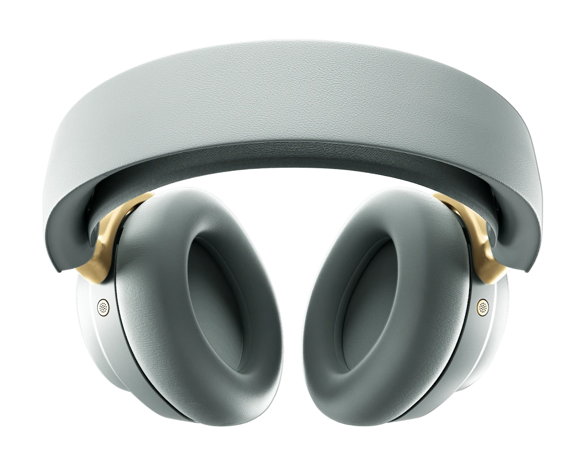 Szare słuchawki na czarnym tle. Złote akcenty na nausznikach. Opaska jasnoszara.