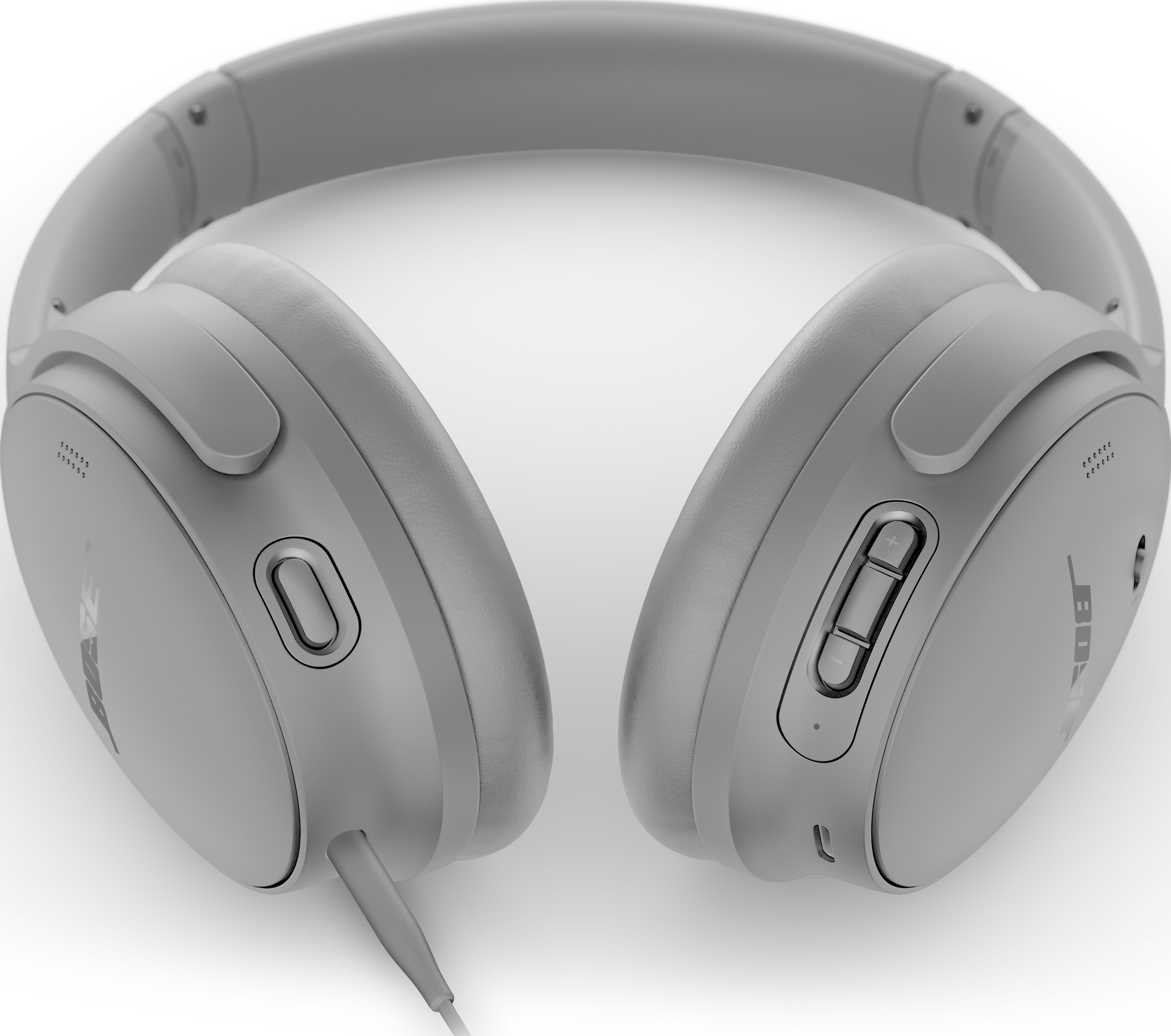 Casque Bose gris sur fond noir. Détails visibles : écouteurs, arceau, boutons et câble.