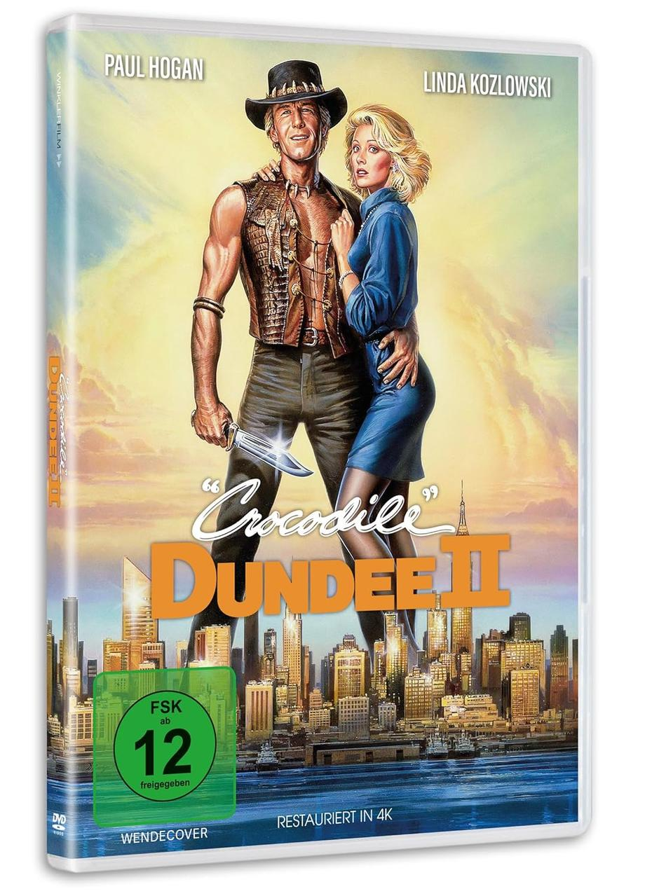 DVD-Hülle für Crocodile Dundee II. Paul Hogan und Linda Kozlowski sind zu sehen. Im Hintergrund eine Stadtlandschaft.