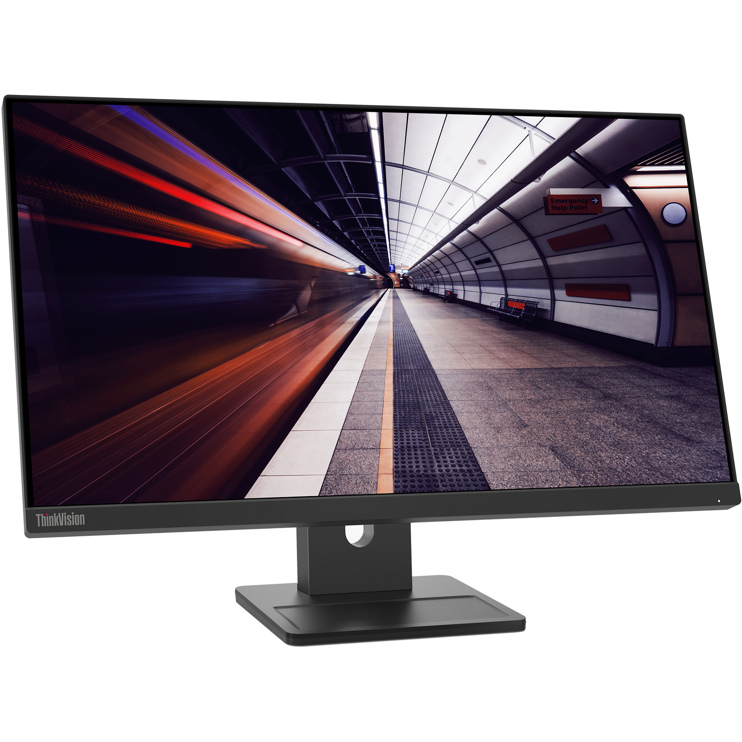 A computer monitor displays a blurred image of a subway tunnel with light trails. The monitor is black and sits on a black stand.