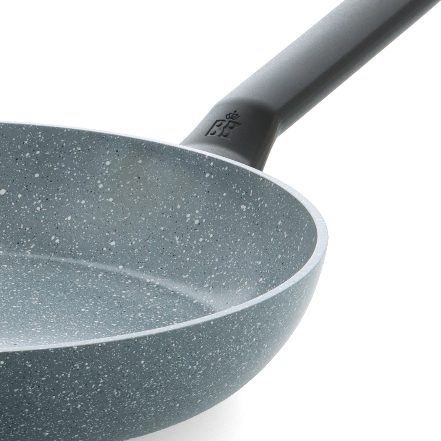 Close-up of a speckled gray frying pan with a dark gray handle. The pan is on a white background. Logo is visible.