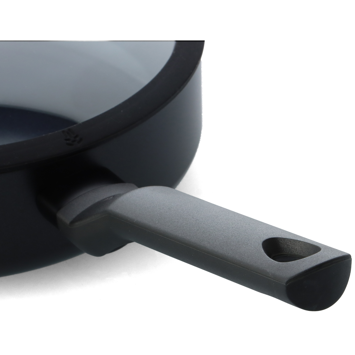 Close-up of a black frying pan with a gray handle. The pan is on a white background. The handle has a hole at its end.