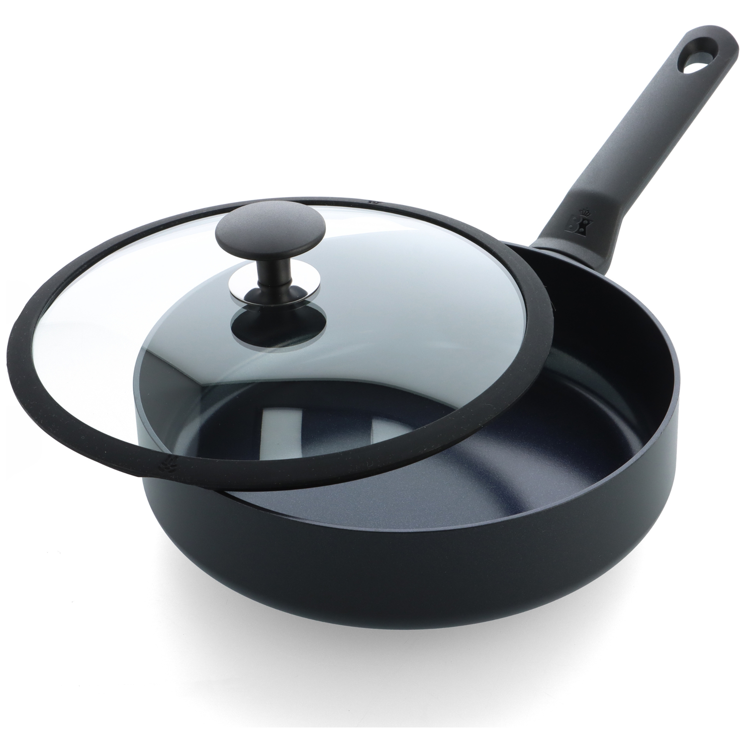 A black frying pan with a glass lid. The lid is partially open. The handle has a hole for hanging.
