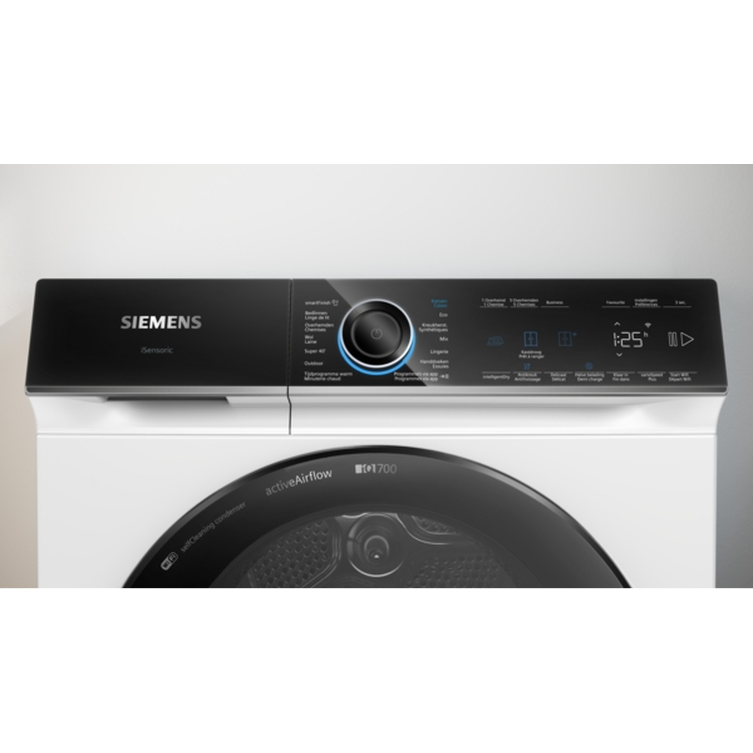 A close-up of a white Siemens dryer with a black control panel. It shows buttons and a digital display, displaying time.