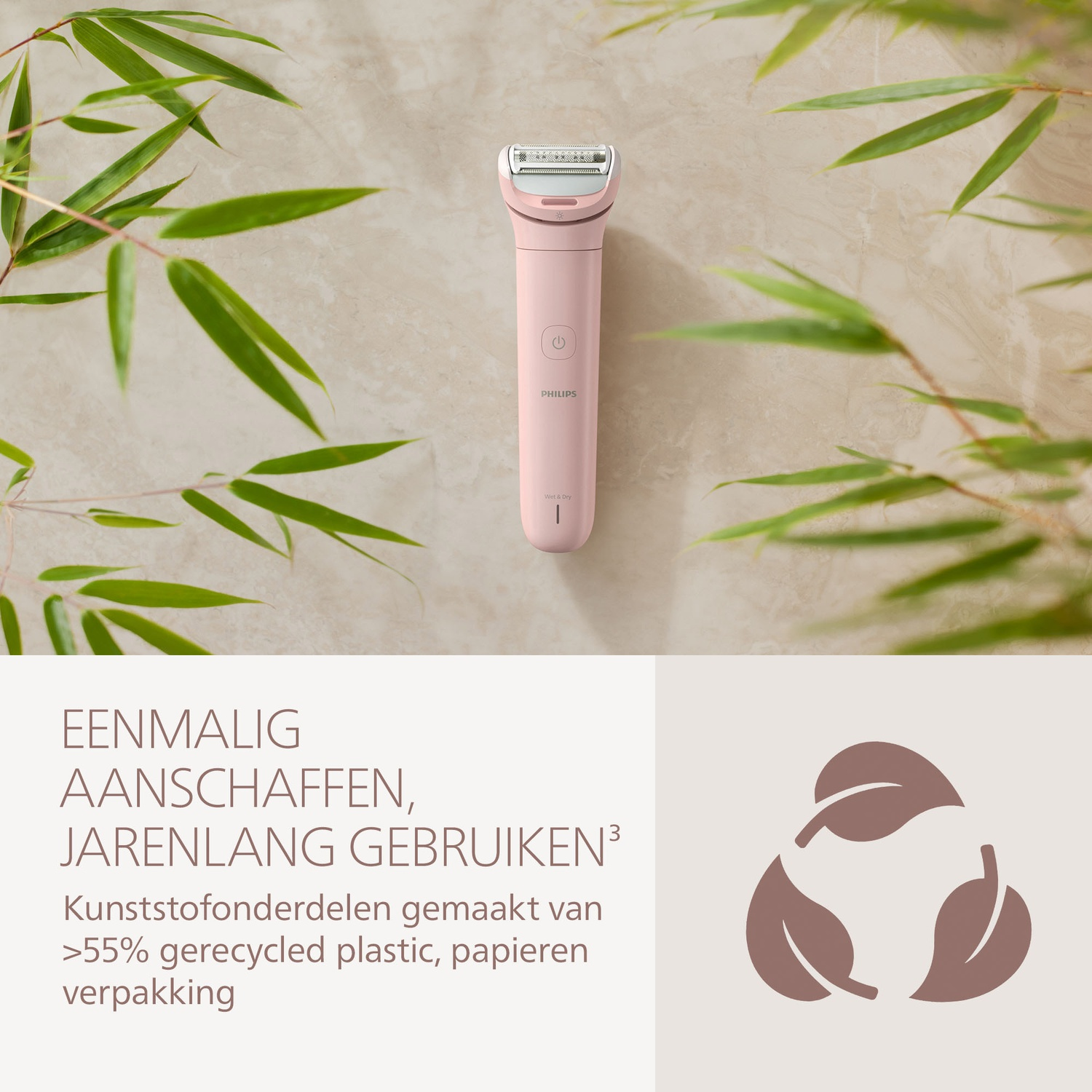 A pink Philips electric shaver, bamboo leaves, and recycling symbol on a light beige background.