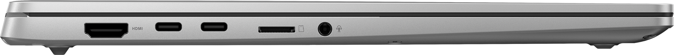Ezüst laptop oldalsó nézete. Látható portok: HDMI, USB-C és audio csatlakozók, fekete háttér előtt.