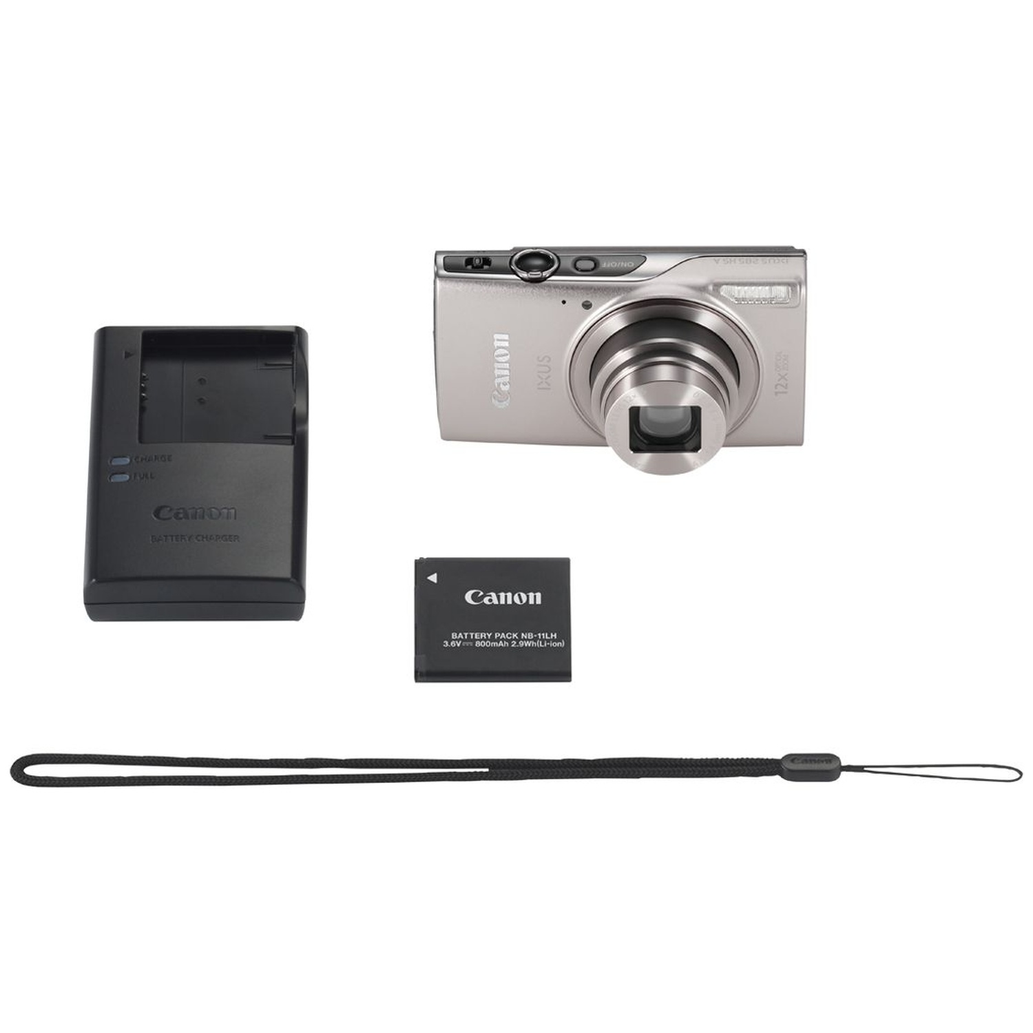 Un kit d'appareil photo Canon avec appareil argenté, chargeur, batterie et dragonne sur fond blanc.