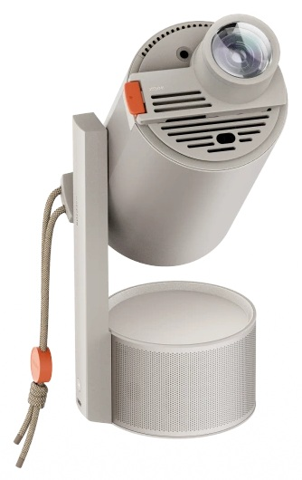 Szary projektor z obiektywem, pomarańczowym przyciskiem i okrągłą podstawą. Sznurek zwisa z boku z pomarańczowym stoperem.