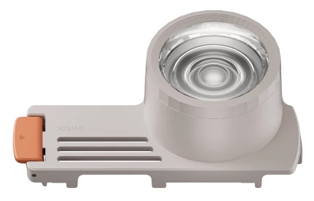 Białe i jasno pomarańczowe urządzenie projekcyjne. Ma obiektyw, podstawę z otworami i pomarańczowy przycisk. Widoczne jest logo XGIMI.