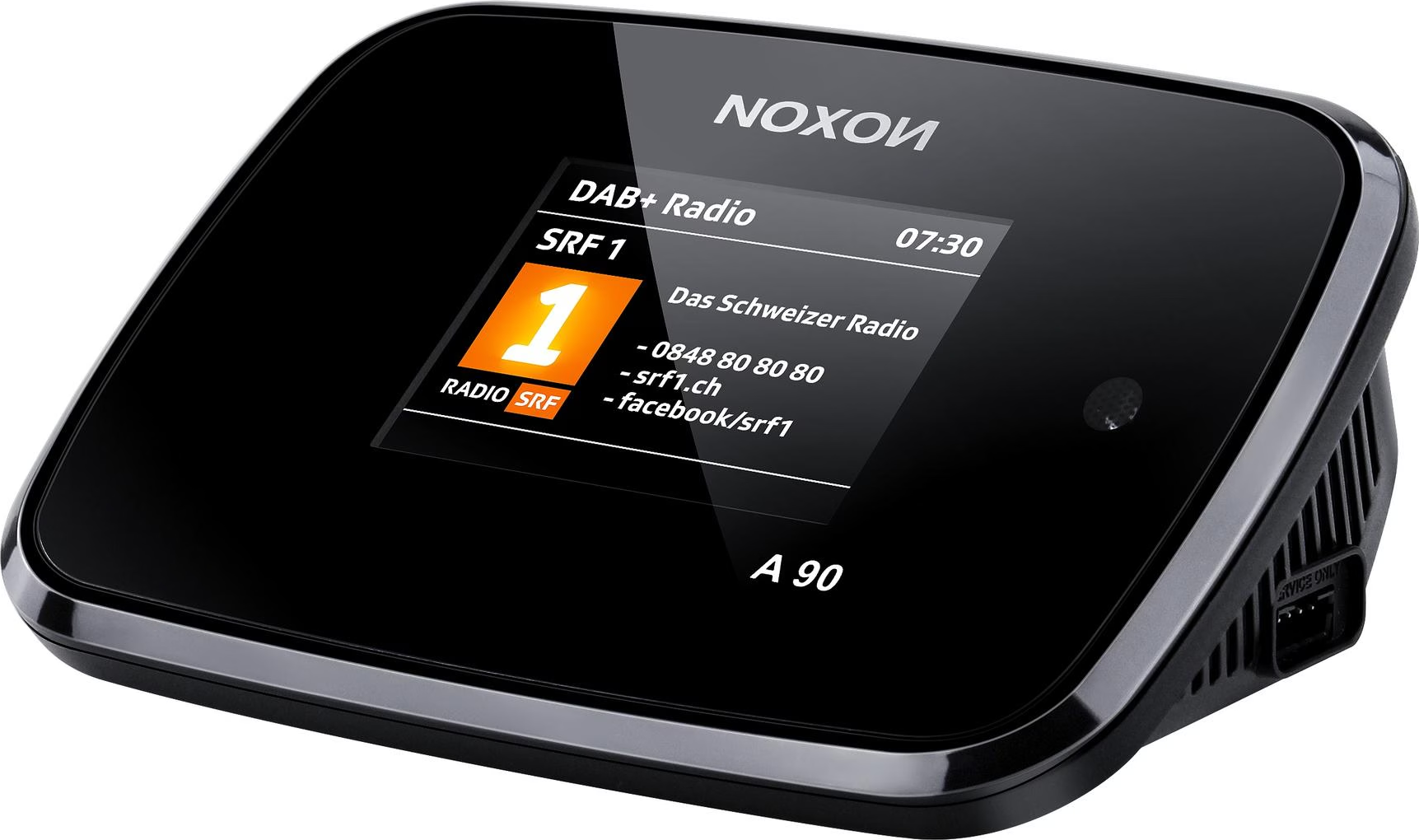 Una radio NOXON A 90 nera. Lo schermo mostra 'SRF 1' con un 1 e sfondo arancione. L'ora è 07:30.