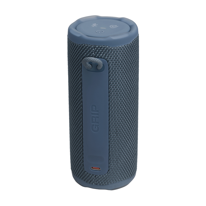 Un altavoz cilíndrico azul con una correa de transporte. El altavoz tiene una superficie texturizada y botones de control.