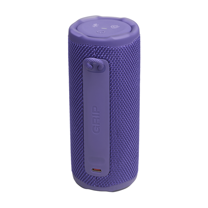 Un altavoz cilíndrico púrpura con una correa y la palabra 'GRIP'. Tiene botones en la parte superior y un puerto de carga en la inferior.
