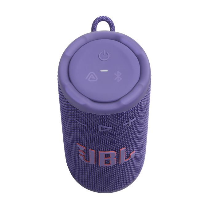 Un altavoz JBL morado con cuerpo de tela y parte superior morada. El logotipo de JBL es naranja. La parte superior tiene botones de encendido, Bluetooth y más.