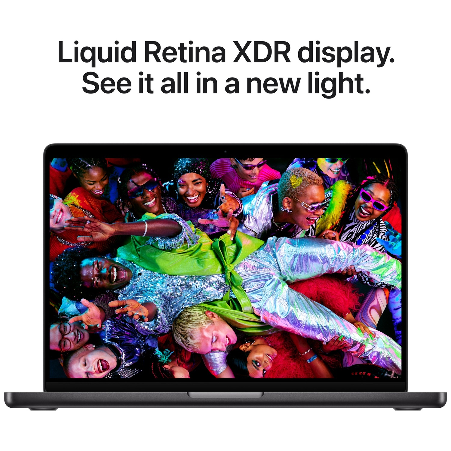 Laptop displays a group of smiling people in colorful clothes. Text above: Liquid Retina XDR display. See it all in a new light.