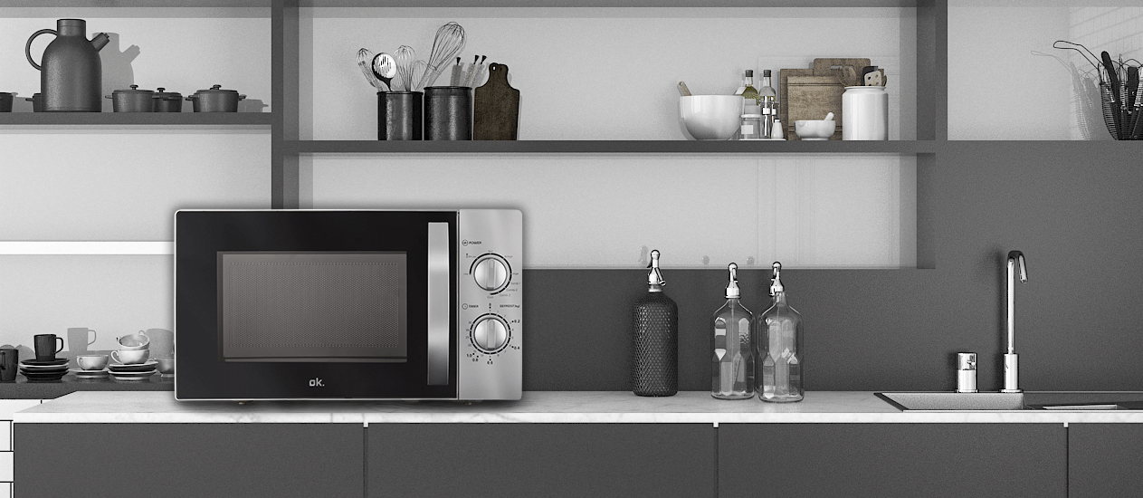 Nowoczesna kuchnia z kuchenką mikrofalową, przyborami kuchennymi i butelkami. Szaro-biała kolorystyka. Kuchenka mikrofalowa jest na środku.