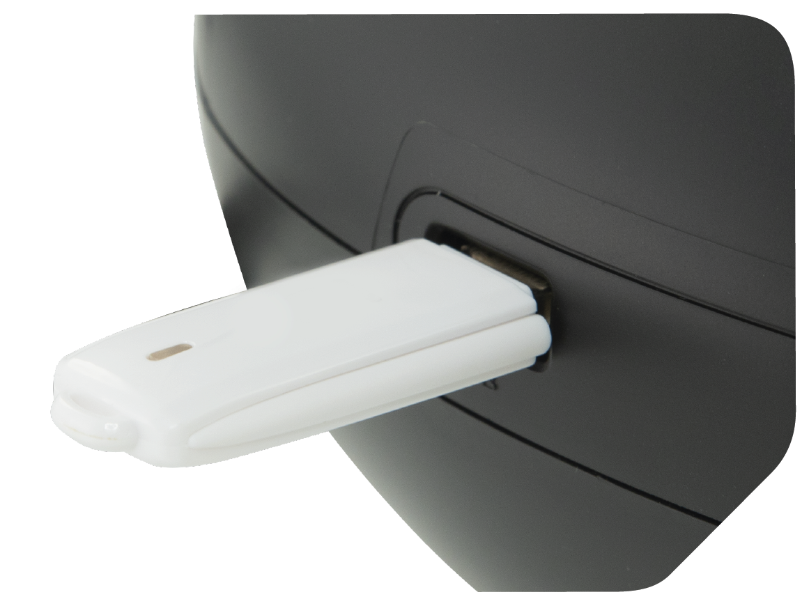 Biały pendrive jest podłączony do czarnego urządzenia. Dysk ma kształt prostokąta z małą lampką kontrolną.