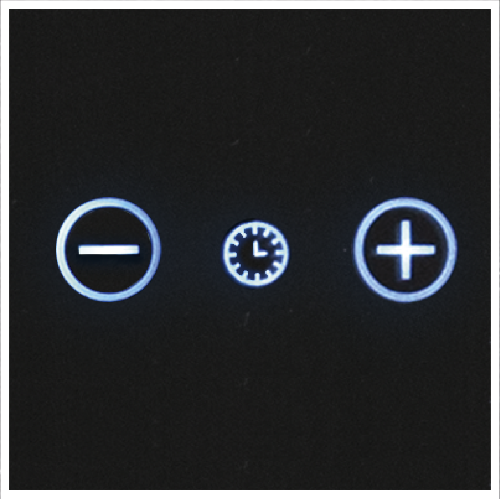 Czarna powierzchnia wyświetla trzy świecące ikony: znak minusa, zegar i znak plusa, wszystkie w okręgach.