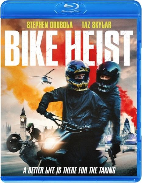 Couverture Blu-ray de "Bike Heist". Deux hommes sur une moto, casques, avec un hélicoptère et des monuments de Londres en arrière-plan.
