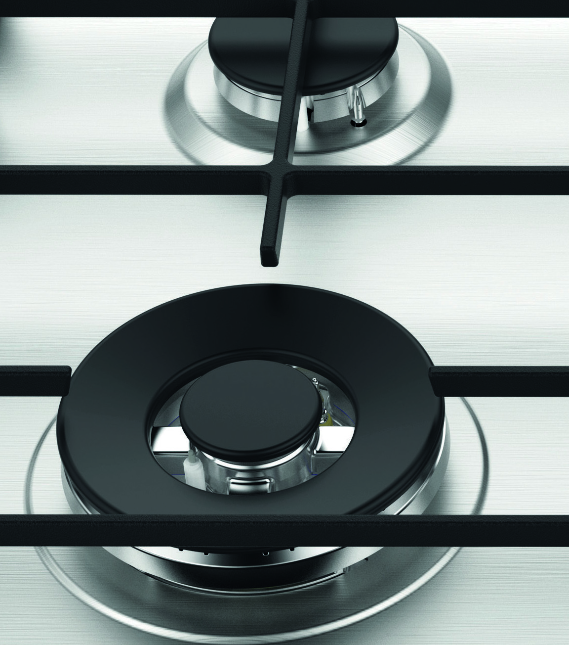 Zbliżenie na stalową kuchenkę gazową z dwoma czarnymi palnikami i rusztami. Widoczny srebrny metal.