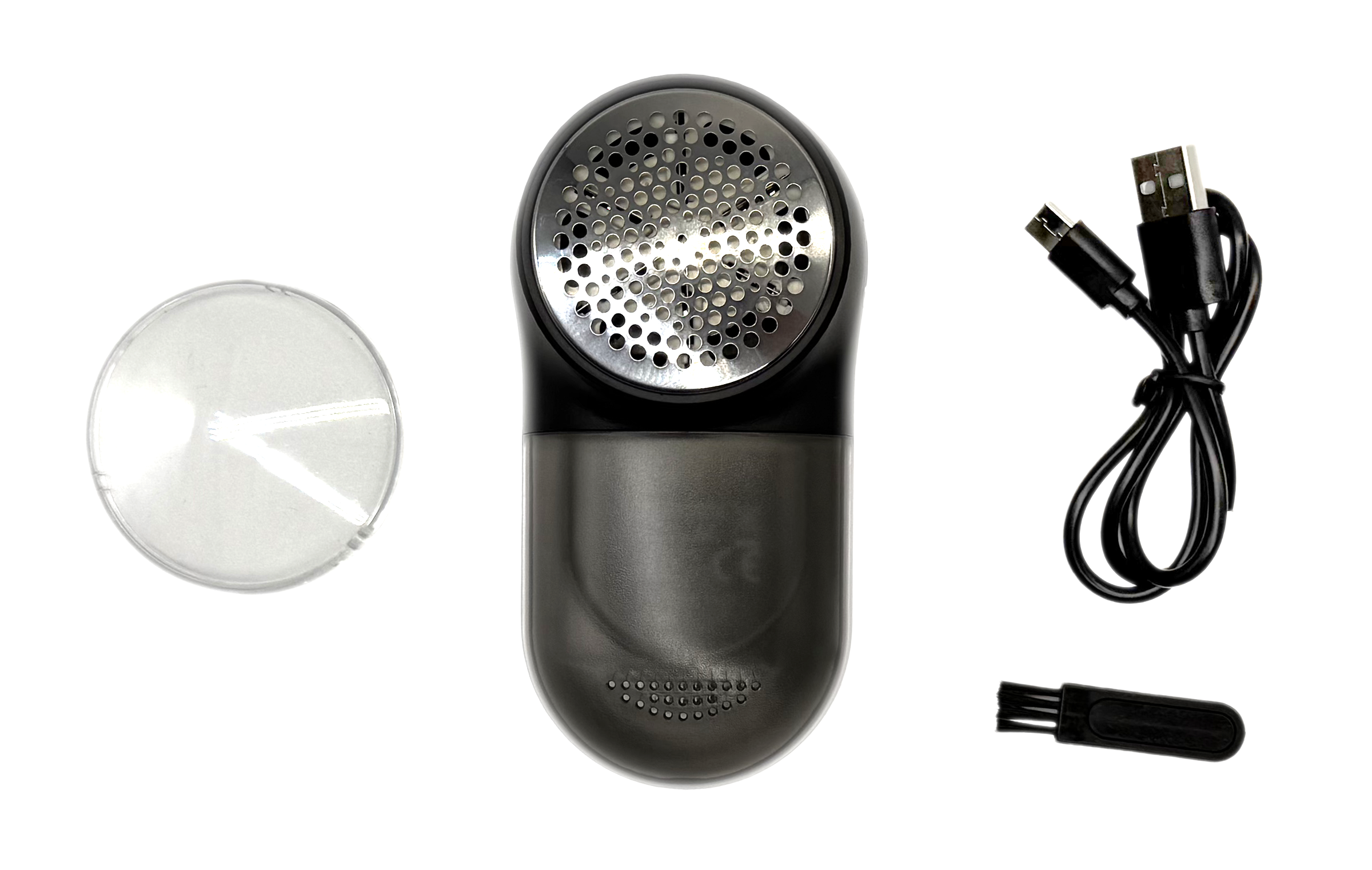 Środek do usuwania kłaczków, przezroczysty pojemnik, czarna szczotka i kabel USB znajdują się na białej powierzchni.