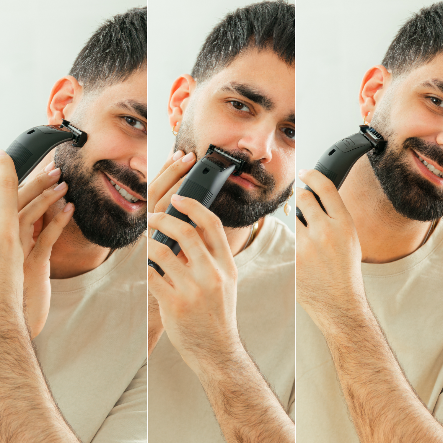 Un hombre se afeita la barba con una recortadora eléctrica. Sonríe, sosteniendo la recortadora en su mejilla. El fondo es liso.