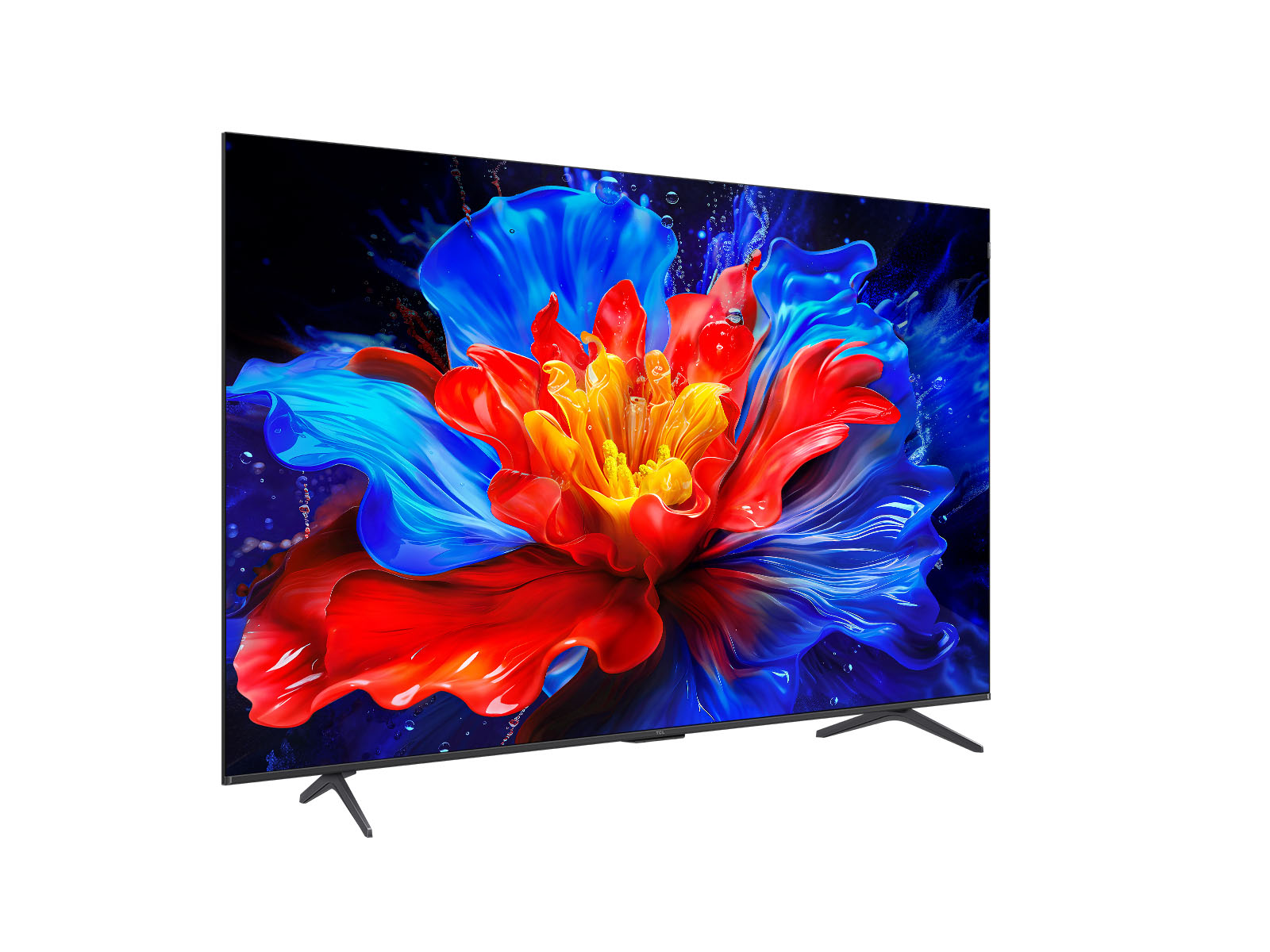 Un televisor grande muestra una imagen floral vibrante. Pétalos rojos, amarillos y azules crean una imagen dinámica sobre un fondo oscuro.
