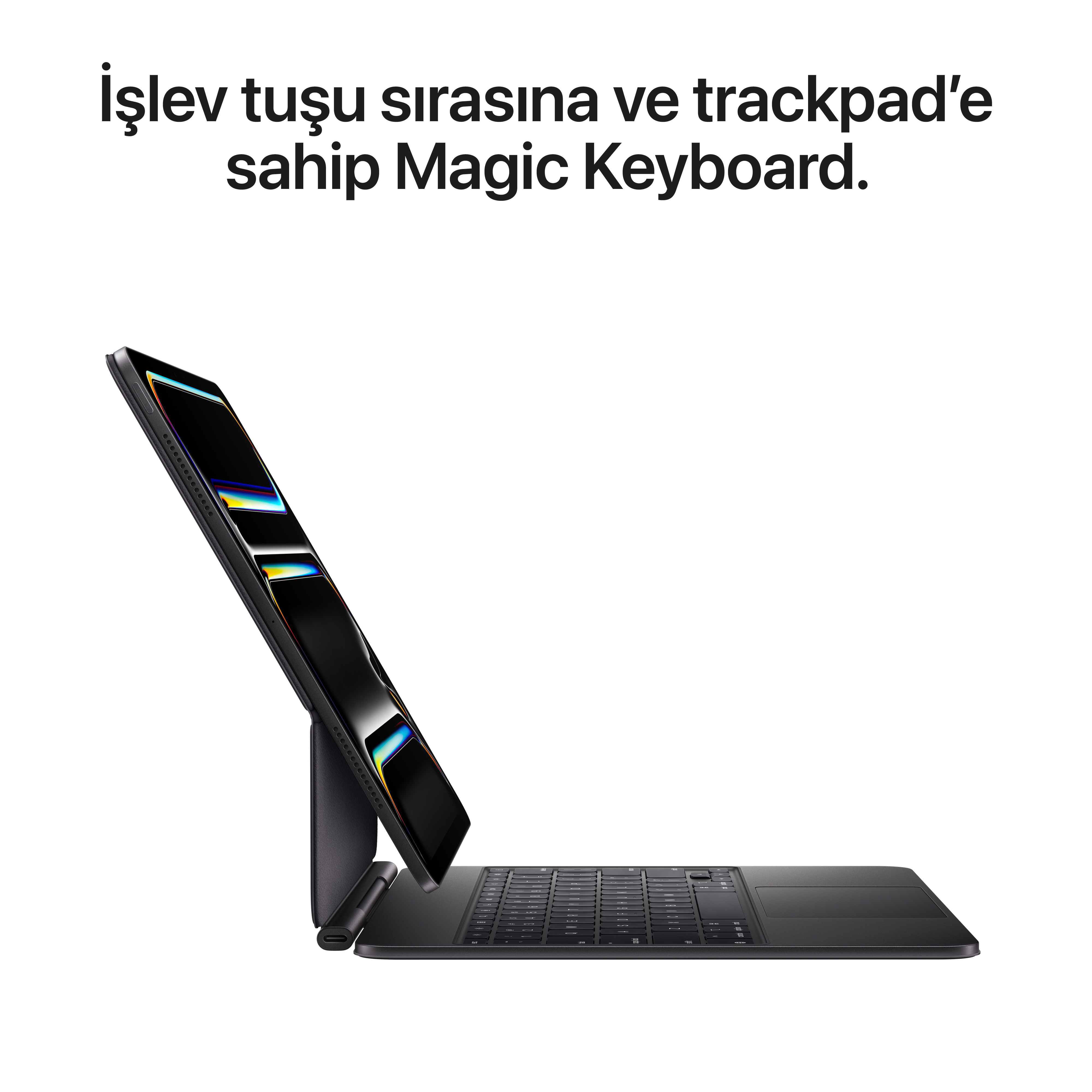 Yukarı doğru eğilmiş, bağlı bir tablet ile siyah bir Magic Keyboard. Klavyede bir izleme dörtgeni ve tuşlar var.