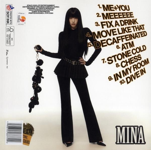 A woman in black clothes holds a black keychain, album cover with text and "MINA" at the bottom. 