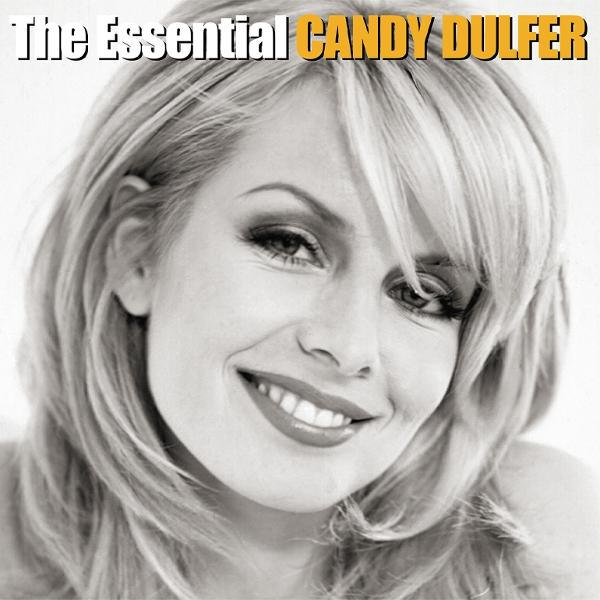 Schwarz-Weiß-Bild von Candy Dulfer, die lächelt. Sie hat blondes Haar und trägt Make-up. Der Text oben lautet 'The Essential Candy Dulfer'.